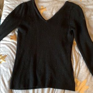 A small knit V-neck sweater/shirt. In black